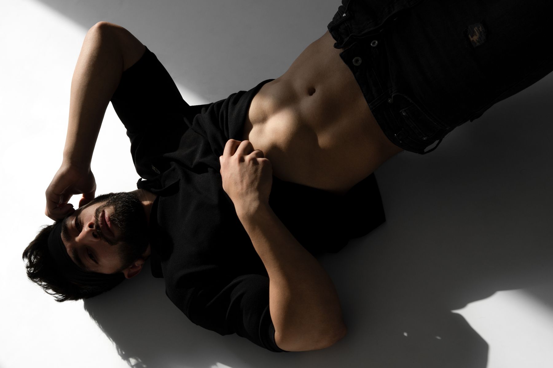 Editorial close-up showing the drape of a black T-shirt