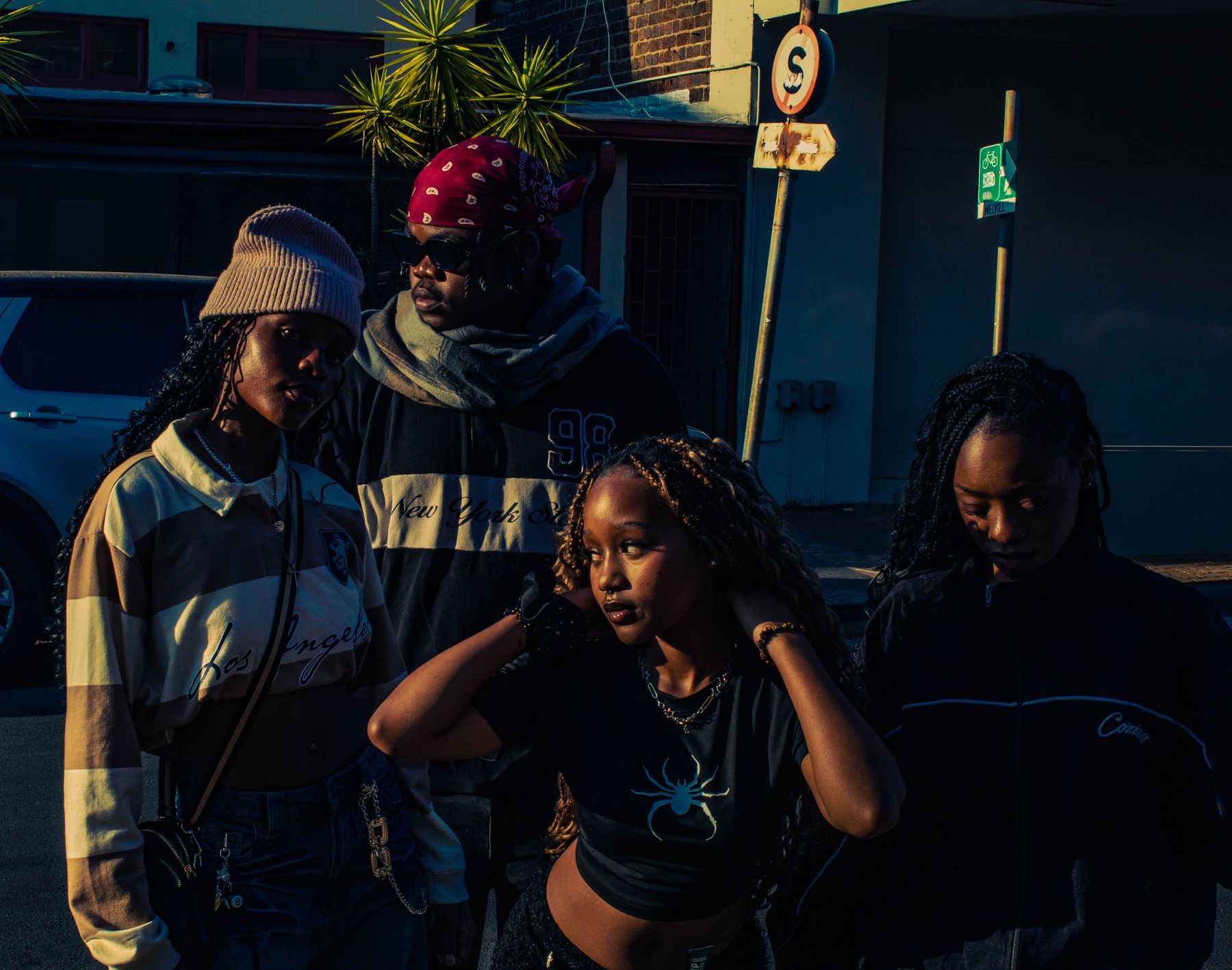 Streetwear group posing together in the city at night